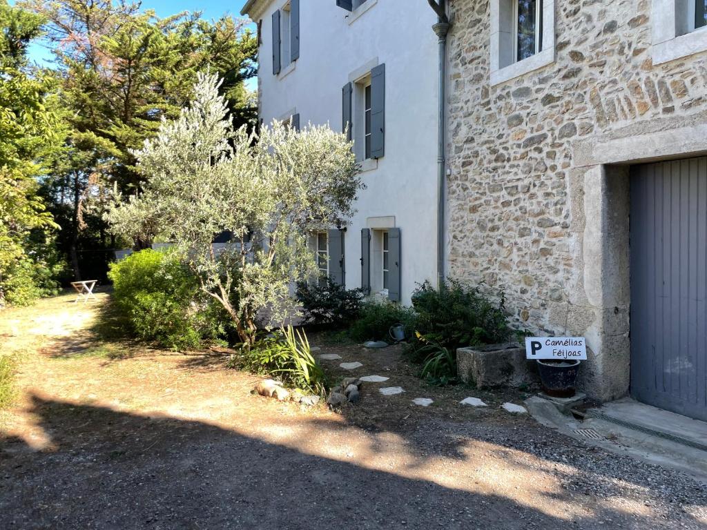 a house with a garage with a sign that says rent at C&O Appartements in Comigne