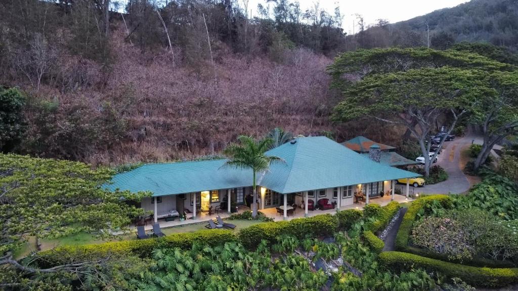 an aerial view of a house with a blue roof at Iao Valley Inn in Wailuku