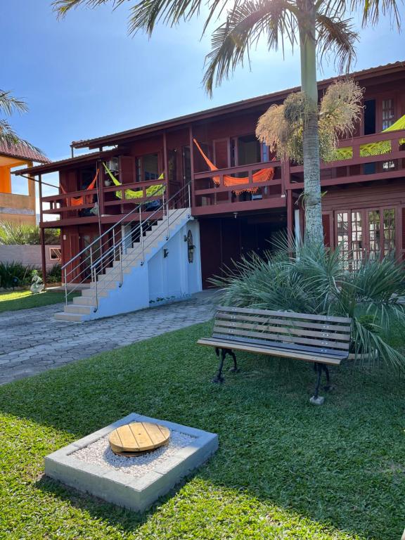 a bench sitting in front of a building at Pousada Recanto do Neca in Florianópolis