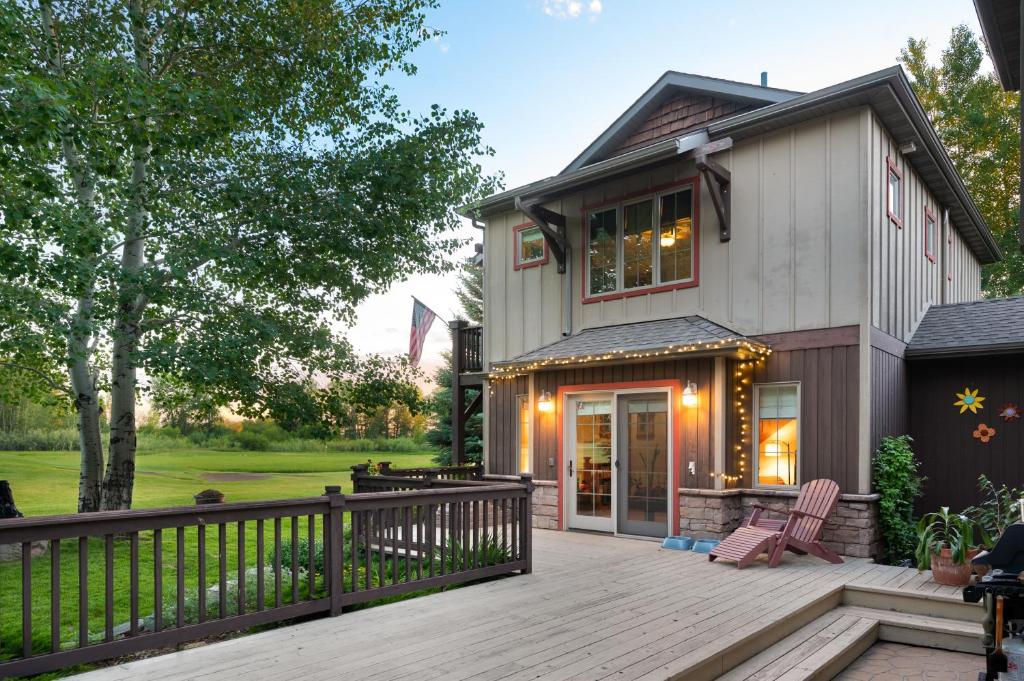 a home with a wooden deck and a house at Adventures From Bozeman's Perfect Location in Bozeman