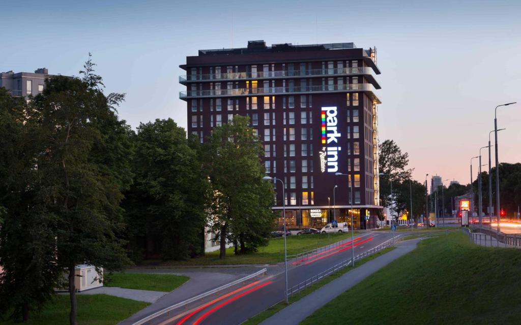 a tall building with a sign on the side of it at Park Inn by Radisson Riga Valdemara in Rīga