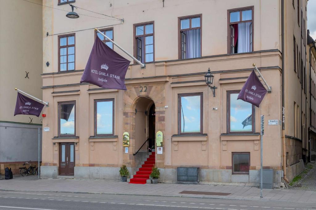 a building with two purple flags in front of it at Hotel Gamla Stan, BW Signature Collection in Stockholm