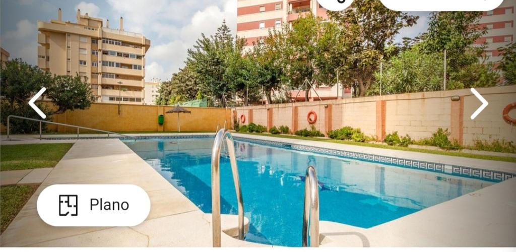 a swimming pool in the middle of a building at Apartamento CANDELA in Fuengirola