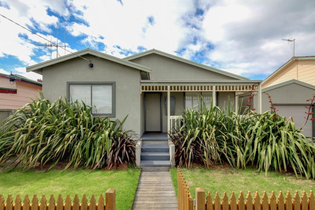 a house with a fence in front of it at Reardon Place in Port Fairy