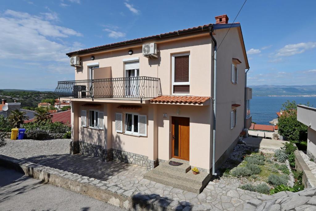 a house with a view of the ocean at Double Room Vrbnik 5299b in Vrbnik
