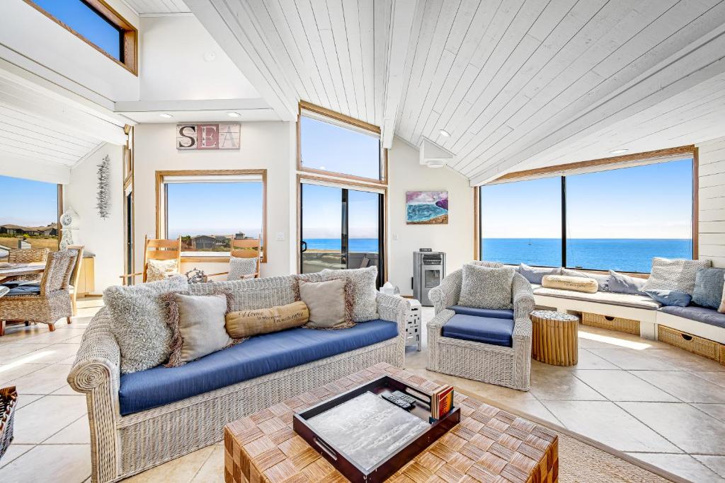 a living room with a blue couch and chairs at Blue Horizon in Bodega Bay