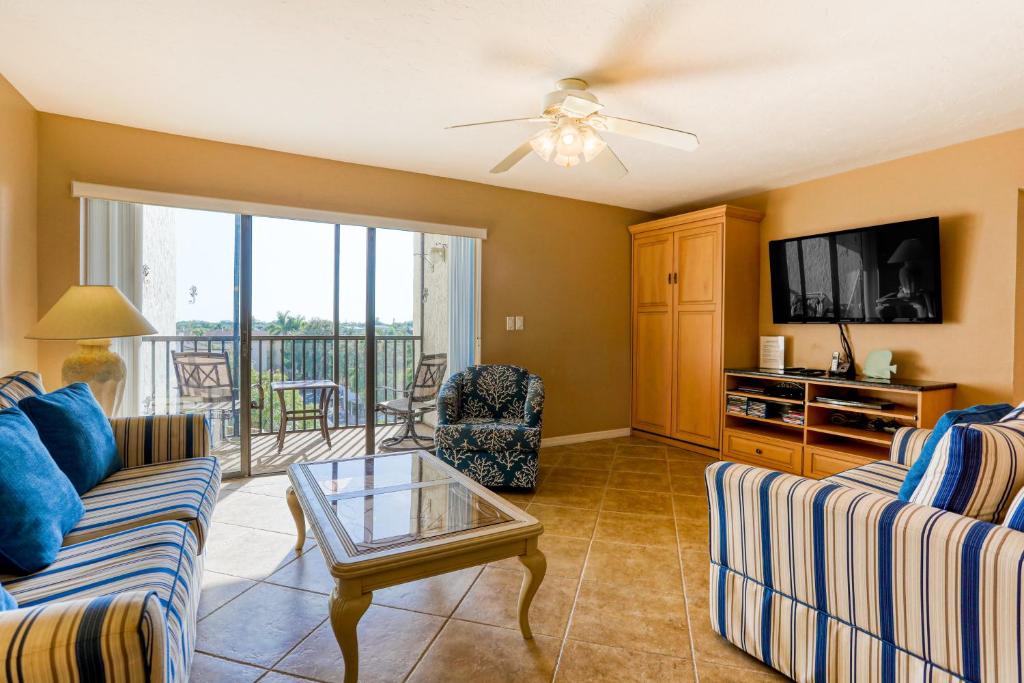 a living room with a couch and a tv at Bay Oaks 75 in Siesta Key