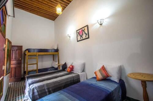 Llit o llits en una habitació de DAR MILOUDA RCIF