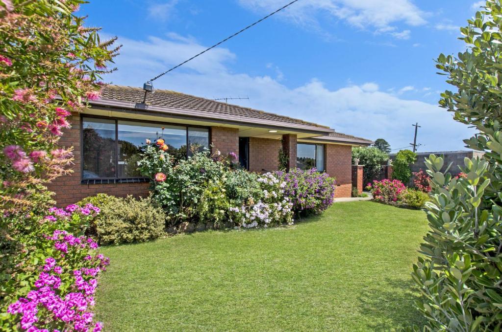 a house with flowers in the yard at Scotshaven in Port Fairy