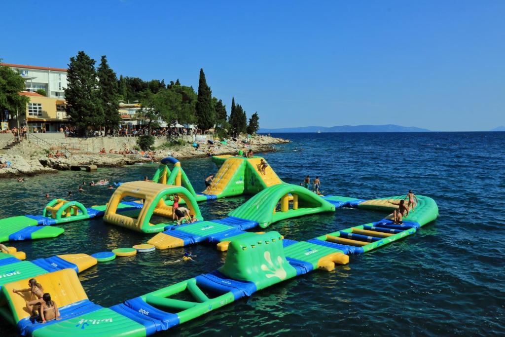 a group of inflatable slides in the water at Apartments with a parking space Rabac, Labin - 7442 in Rabac