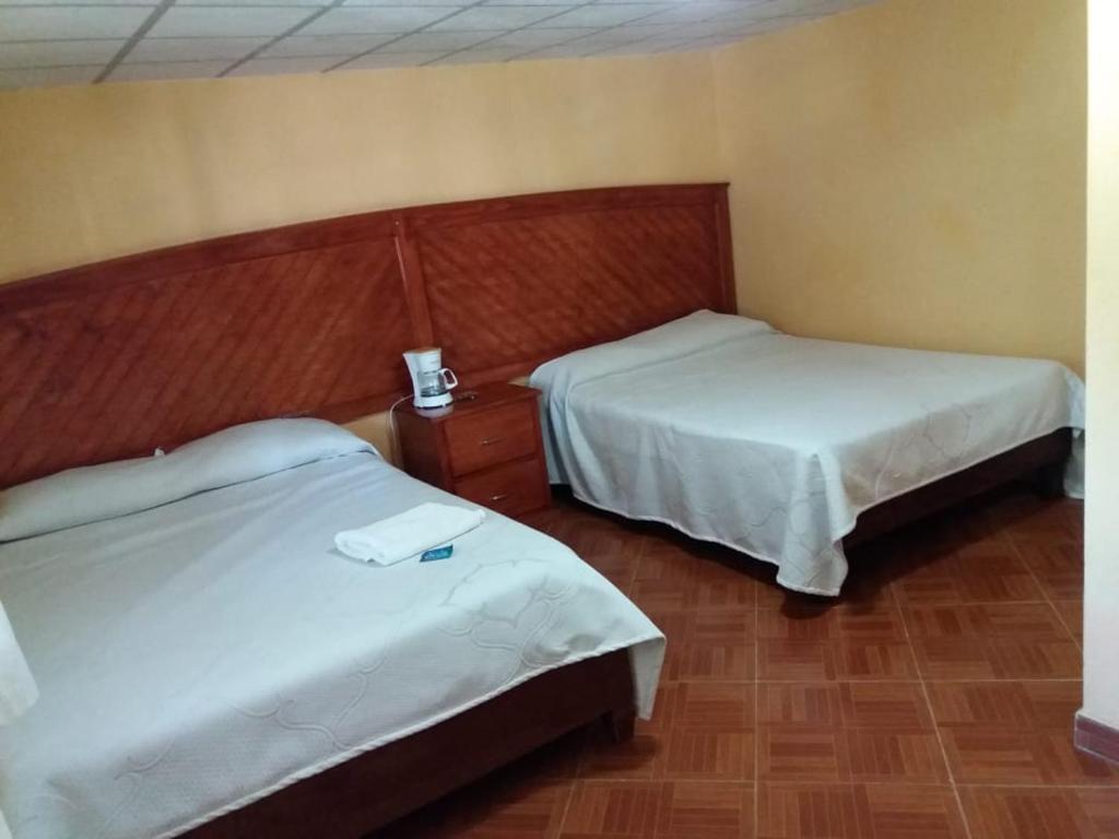 Postel nebo postele na pokoji v ubytování HOTEL RESTAURANT LOS PRISMAS