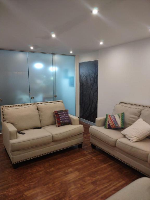 uma sala de estar com dois sofás num quarto em DEPARTAMENTO RECAVARREN (SURQUILLO/MIRAFLORES) em Lima