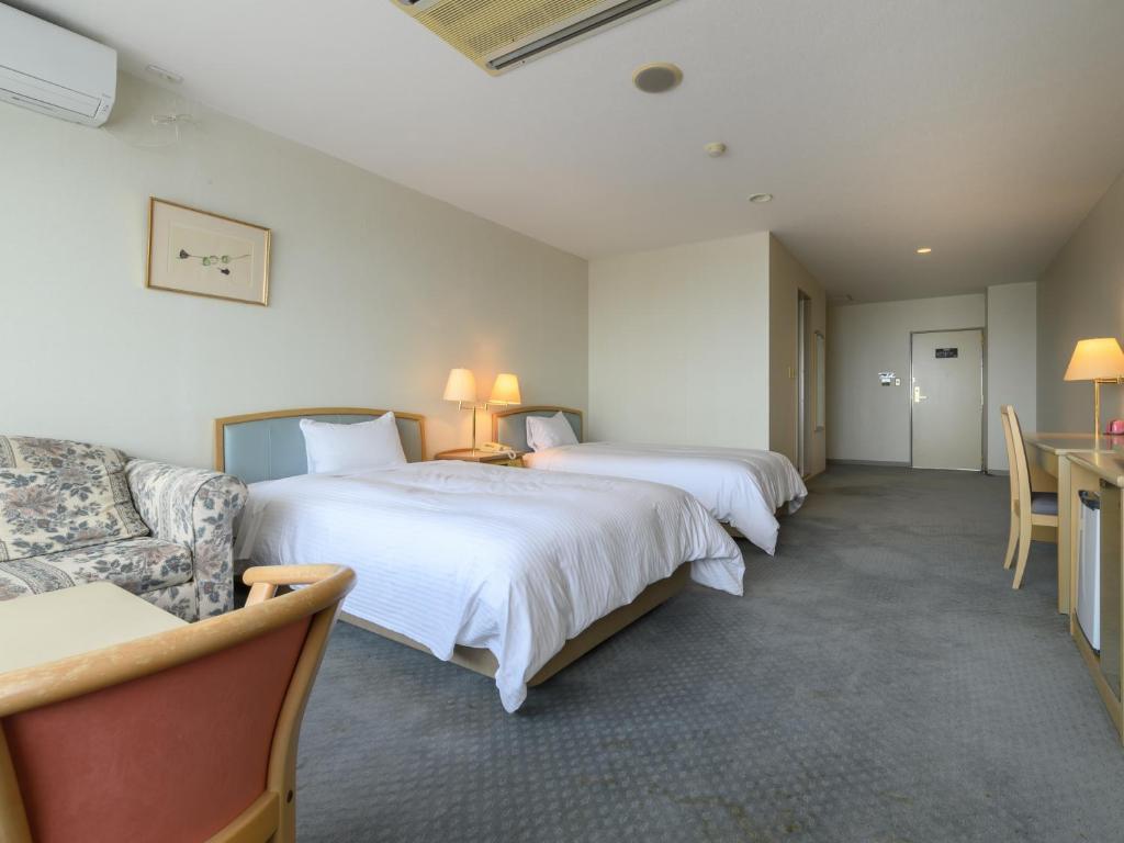Postel nebo postele na pokoji v ubytování Tabist Katahara Resort Gamagori