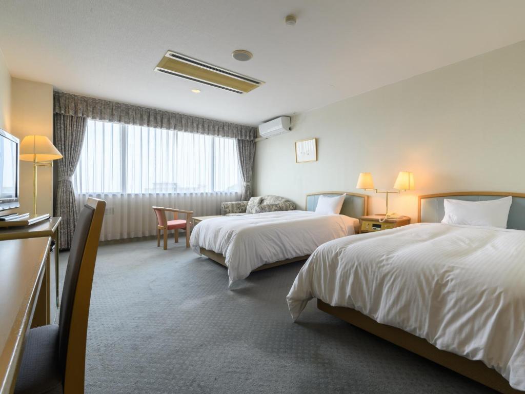 Postel nebo postele na pokoji v ubytování Tabist Katahara Resort Gamagori