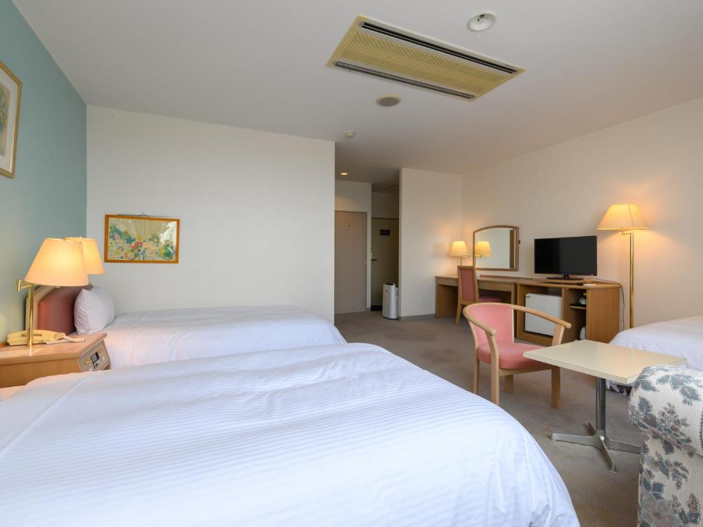 Postel nebo postele na pokoji v ubytování Tabist Katahara Resort Gamagori