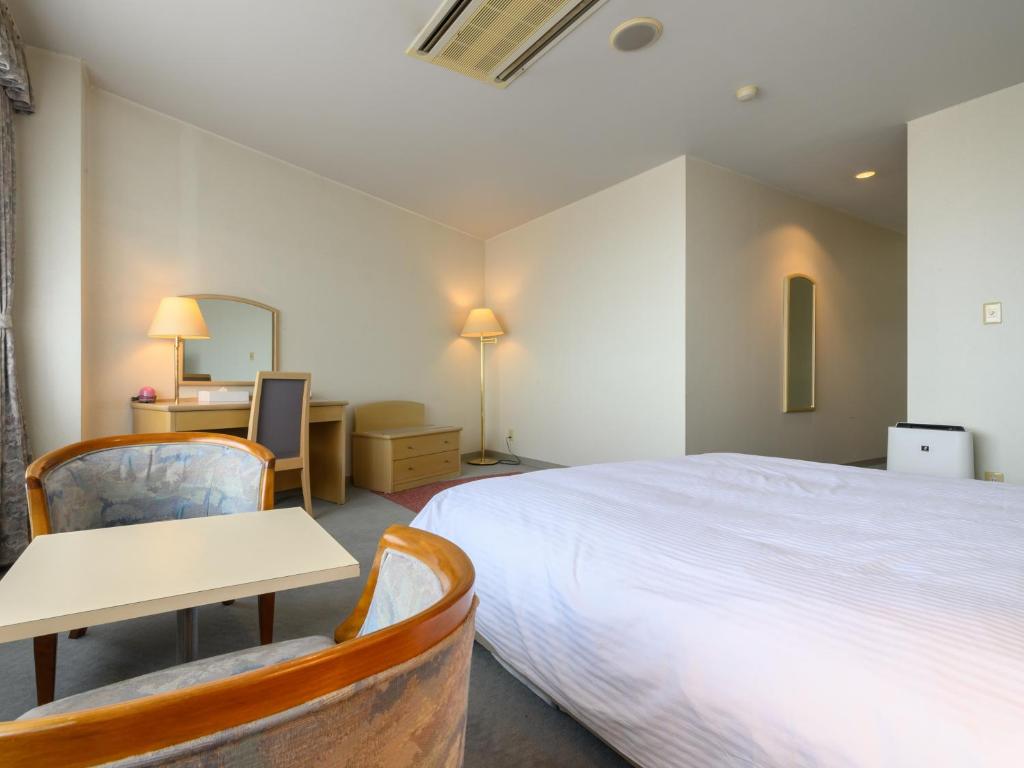 Postel nebo postele na pokoji v ubytování Tabist Katahara Resort Gamagori