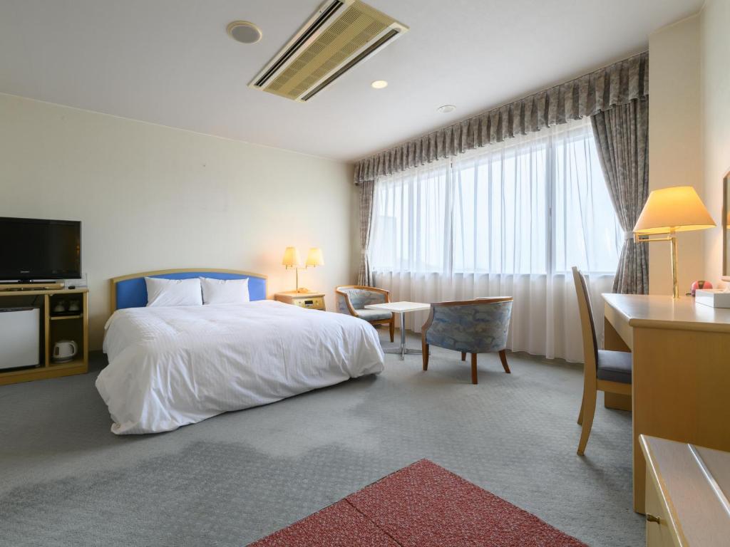Postel nebo postele na pokoji v ubytování Tabist Katahara Resort Gamagori