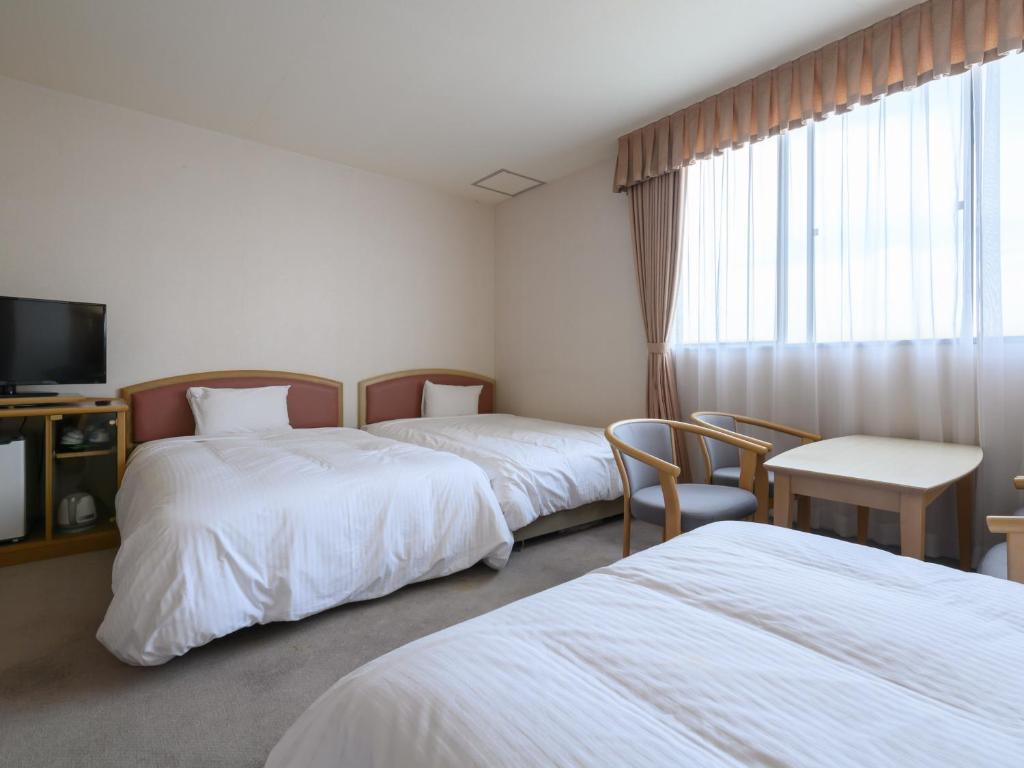 Postel nebo postele na pokoji v ubytování Tabist Katahara Resort Gamagori