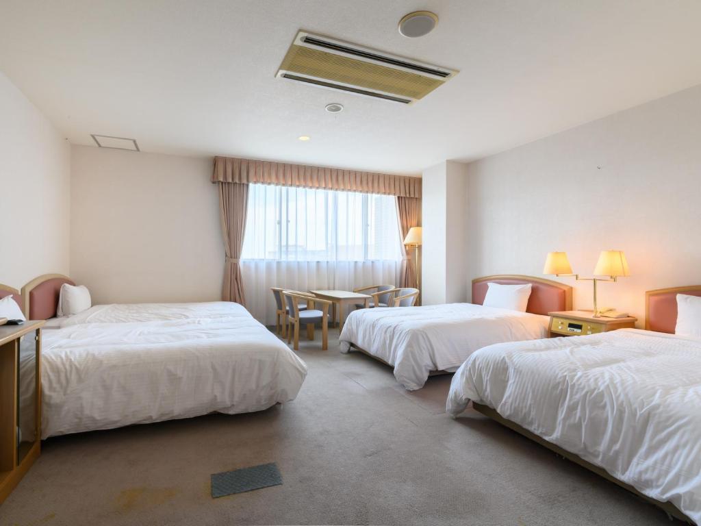 Postel nebo postele na pokoji v ubytování Tabist Katahara Resort Gamagori