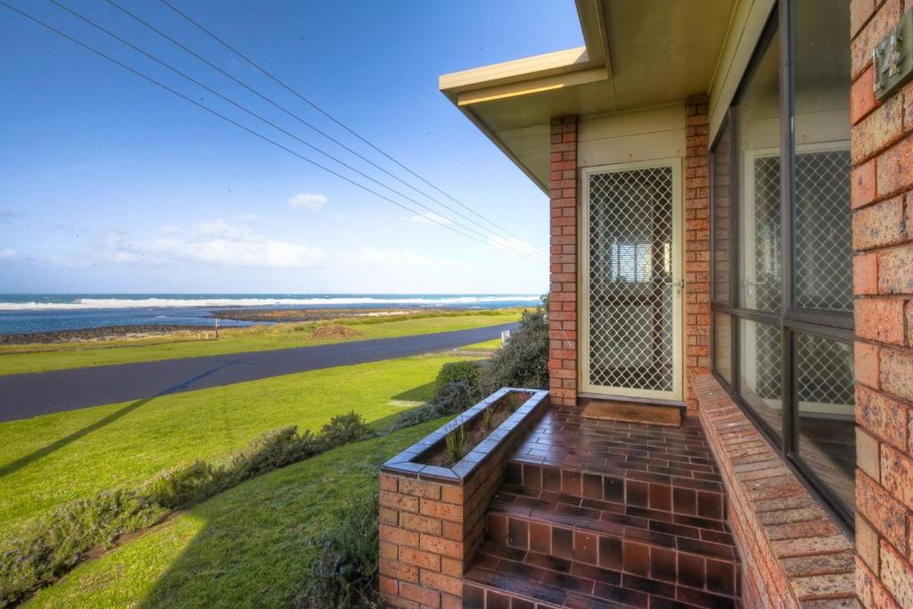 a house with a balcony with a view of the ocean at Swimmers Rest 1 Bedroom in Port Fairy
