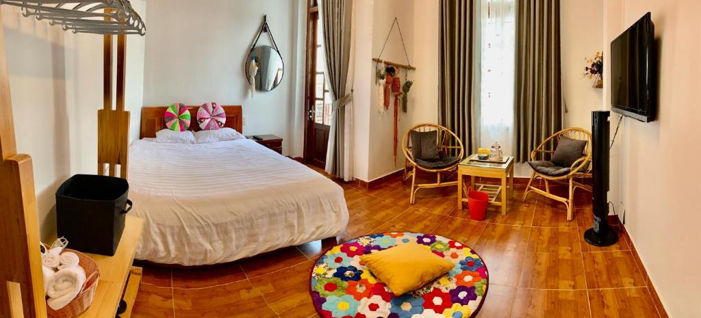 - une chambre avec un lit, une table et des chaises dans l'établissement Homestay Ahihi Đà Lạt, à Đà Lạt