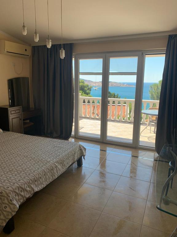 a bedroom with a bed and a view of the ocean at Imperia in Bar