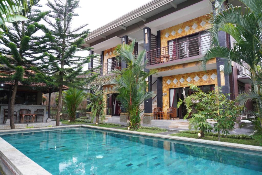 a villa with a swimming pool in front of a building at Puri Bisma Ubud - 4 Bedroom PRIVATE VILLA - 10 min walking to Ubud Center in Ubud