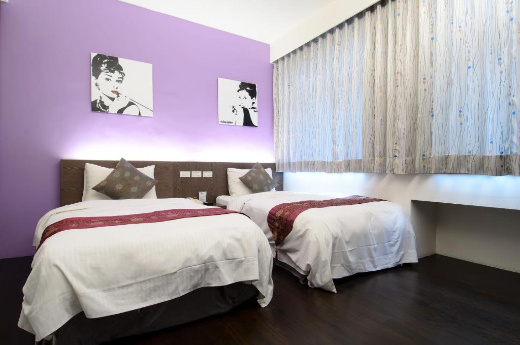 Postel nebo postele na pokoji v ubytování Yuh-Tarng Hotel