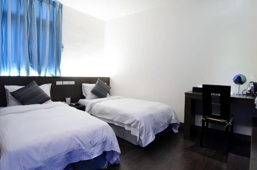 Postel nebo postele na pokoji v ubytování Yuh-Tarng Hotel
