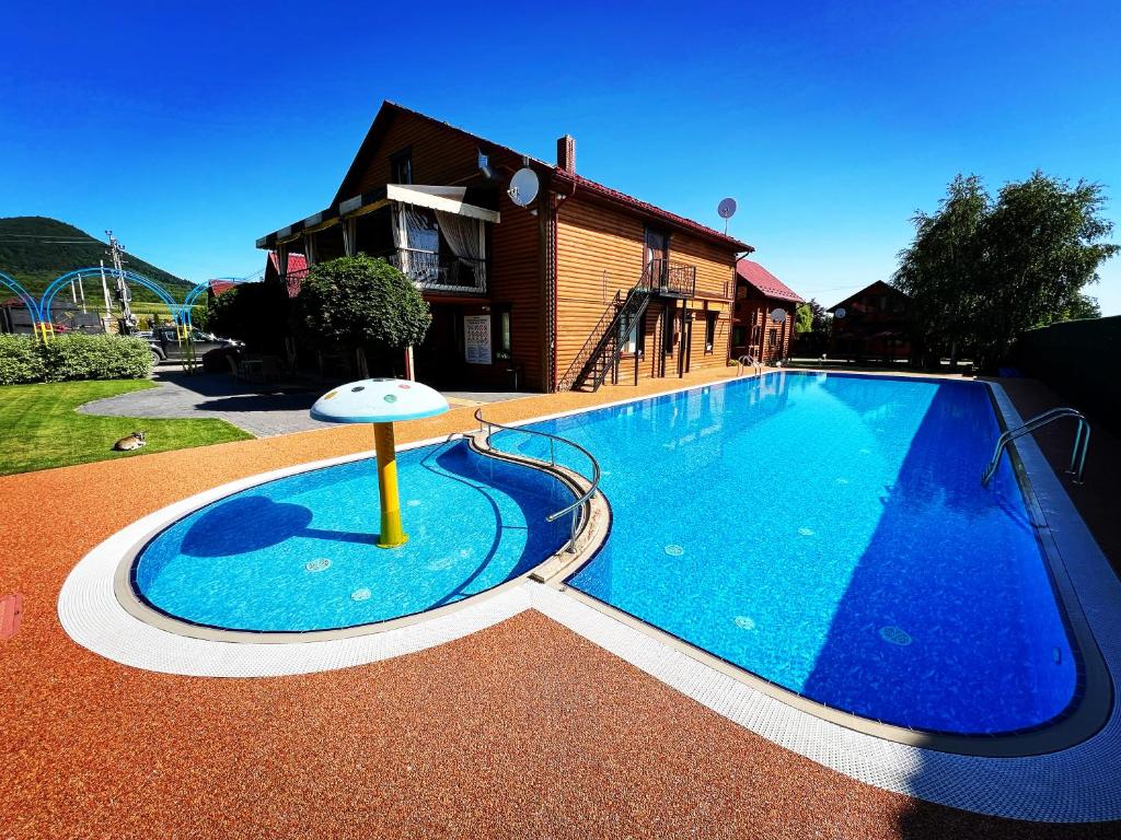 a large swimming pool in front of a house at GorodOk in Migovo