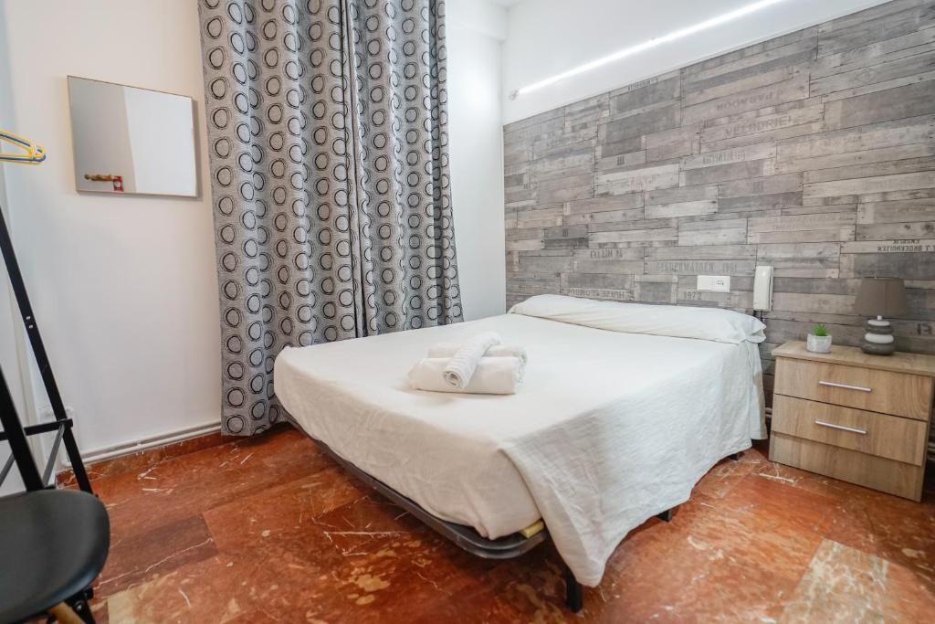 A bed or beds in a room at Hostal Nevot