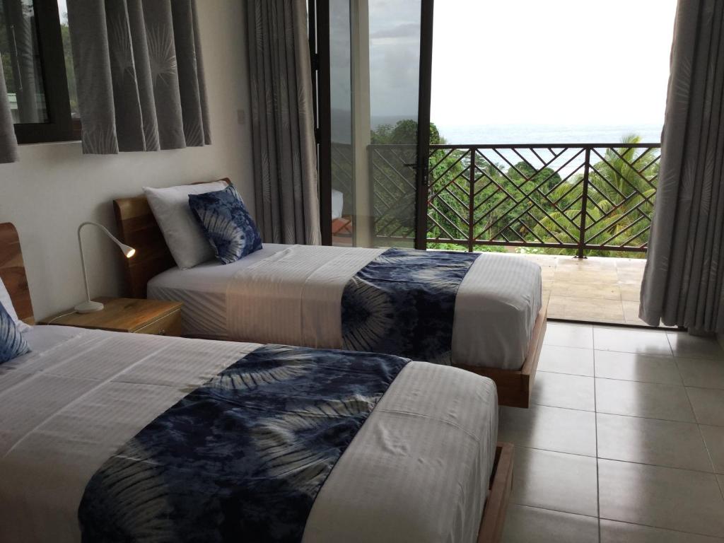Postel nebo postele na pokoji v ubytování Bougainvillas Seychelles