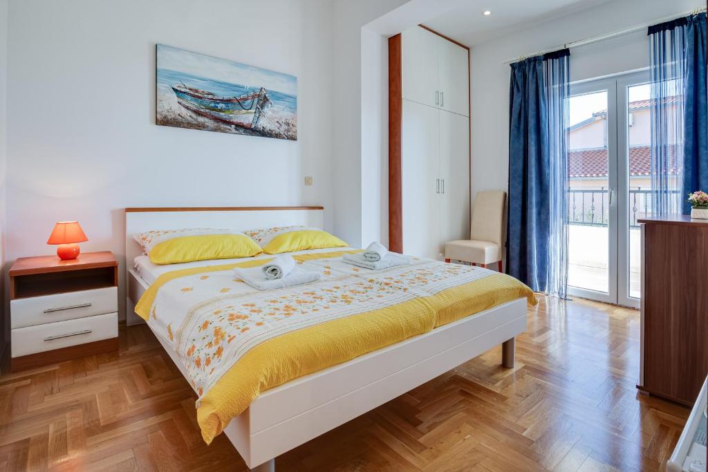 a bedroom with a bed and a large window at Casa Dalmatia in Krvavica
