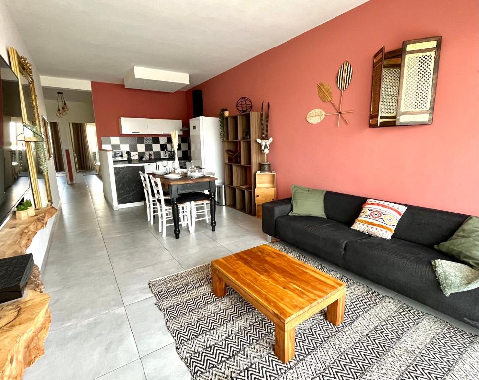 a living room with a black couch and a table at 2 Bedrooms - Sea View Apartment in Nice