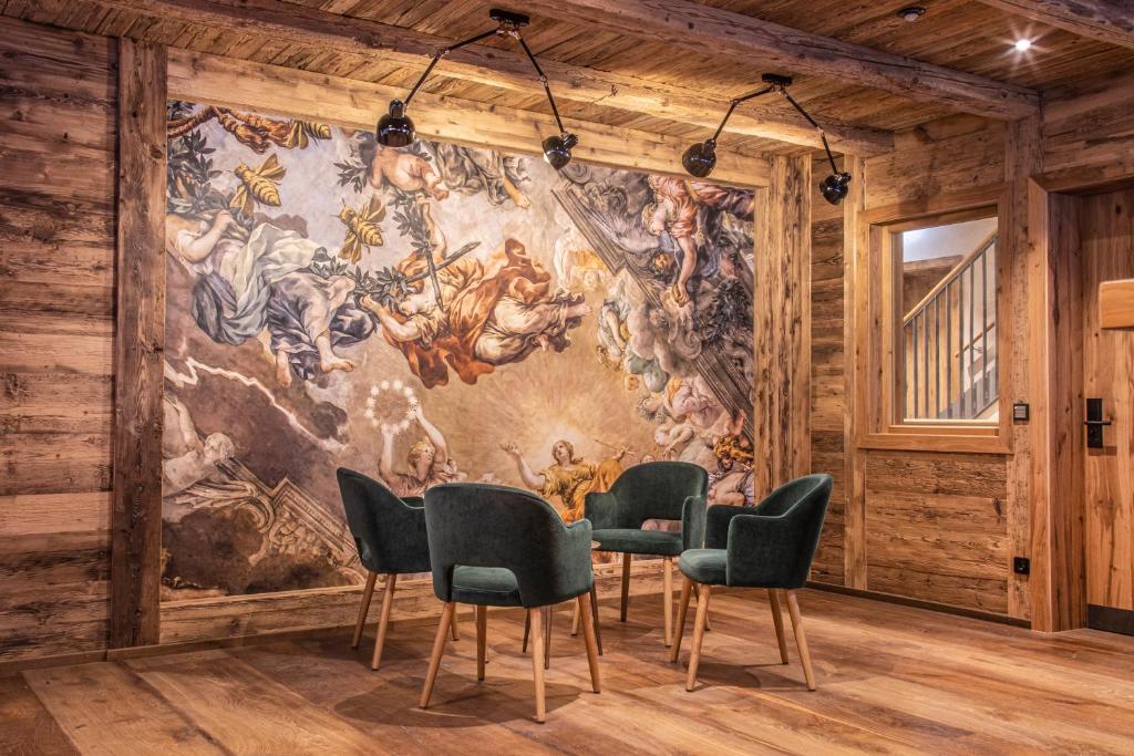 a meeting room with a large mural on the wall at Berghaus Schröcken - Hotel Apartments Spa in Schröcken