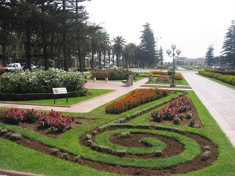 a garden with a spiral in the grass with flowers at Residence Imane in Mohammedia