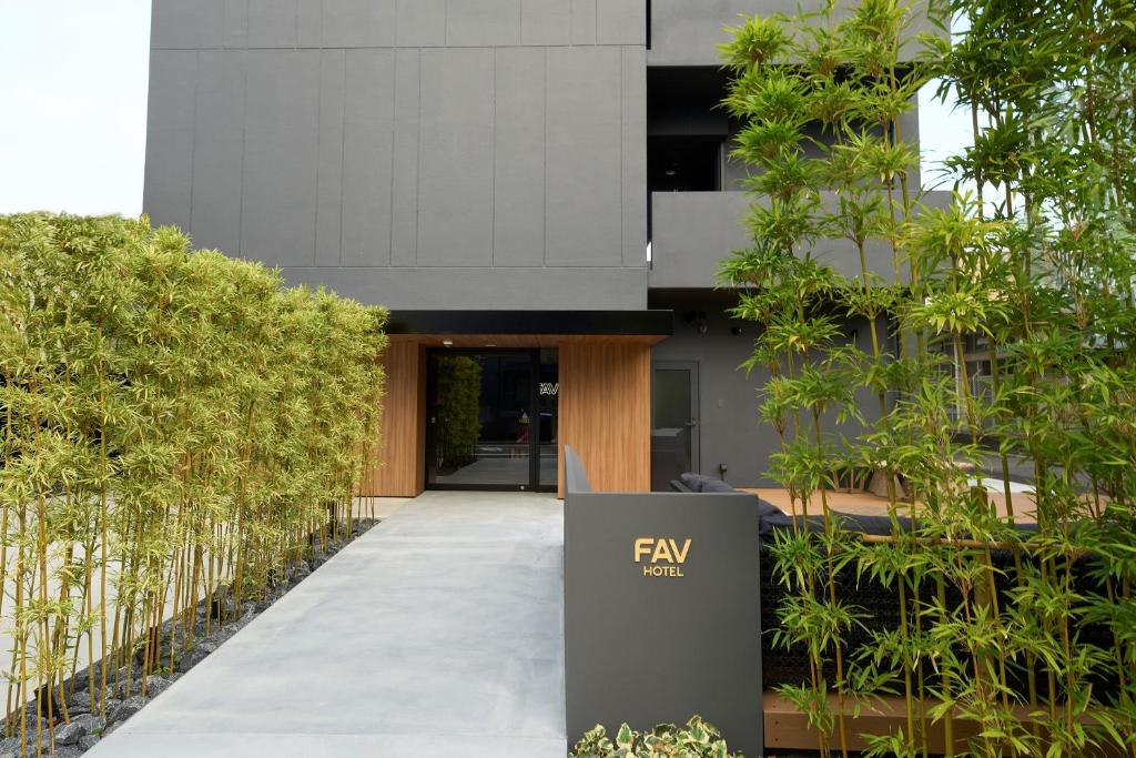 a building with a fryn sign in front of it at FAV HOTEL HIROSHIMA STADIUM in Hiroshima