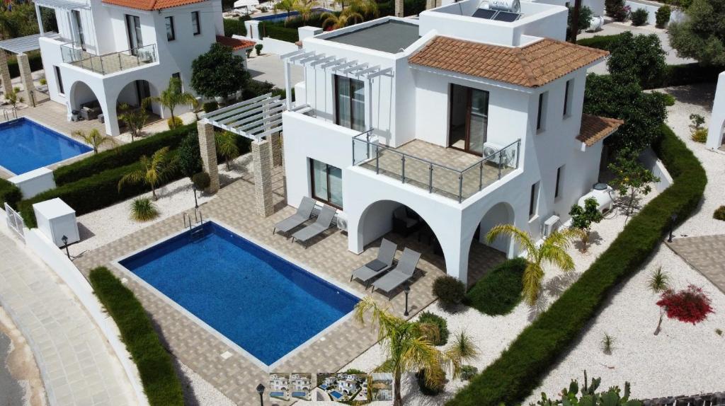 an aerial view of a villa with a swimming pool at St. Georgiana Villa 7 in Peyia