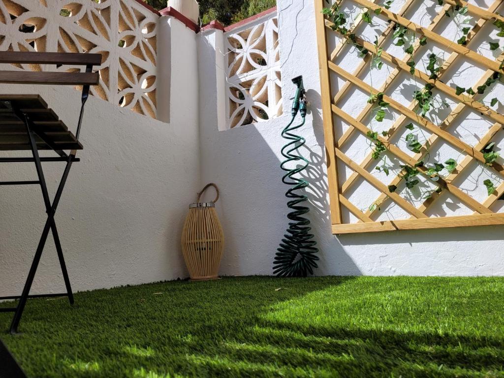 a room with a window and a green lawn at "COZY LOFT", TERRACE, PARKING and SWIMMING POOL in Málaga