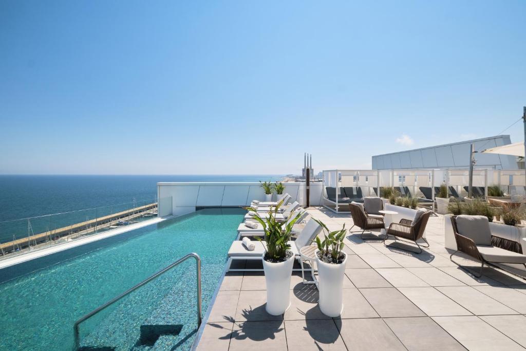 a swimming pool on the roof of a building at Hotel Marina Badalona in Badalona