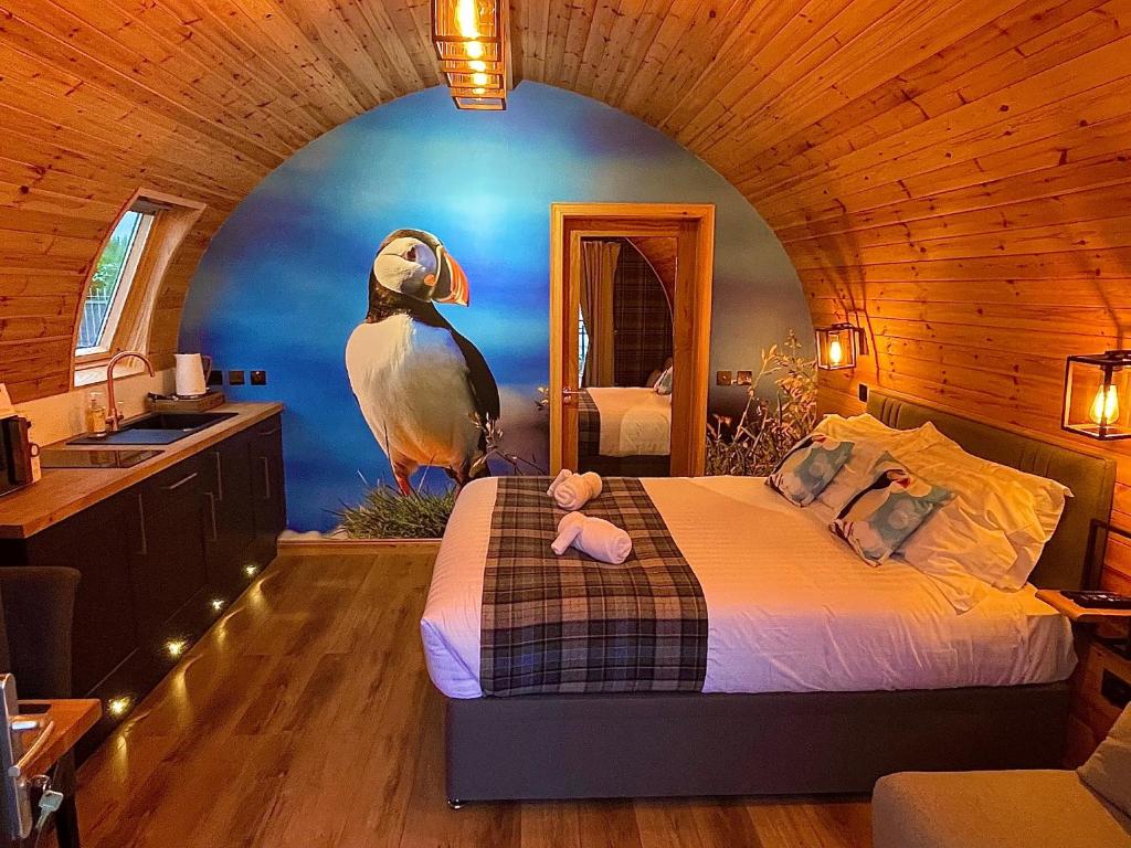 a bedroom with a large bird on the wall at 3 Sinclair Bay Lodges in Keiss