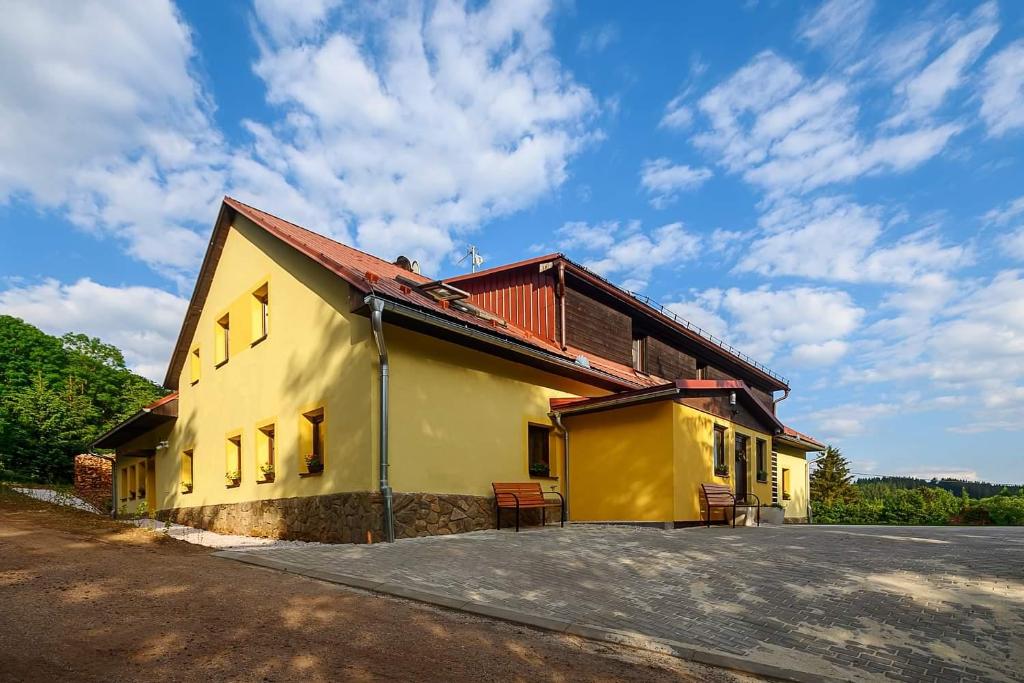 a yellow house with a red roof at Chalupa Křenov 62 in Bernartice