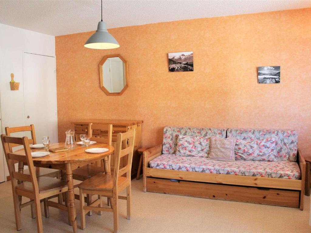 a living room with a table and a couch at Appartement Vars, 1 pièce, 6 personnes - FR-1-330B-138 in Vars