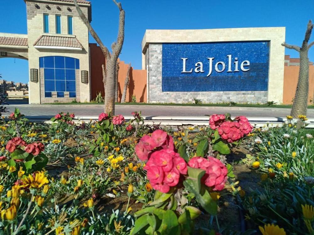 a sign for a library with flowers in front of it at Cozy Chalet in El Ain El Sokhna شالية بالعين السخنة in Ain Sokhna