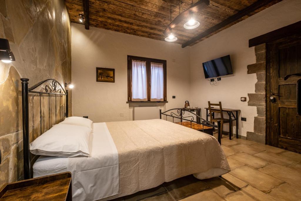 Postel nebo postele na pokoji v ubytování Il Rifugio dei Minatori