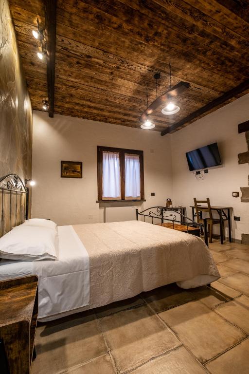 Postel nebo postele na pokoji v ubytování Il Rifugio dei Minatori
