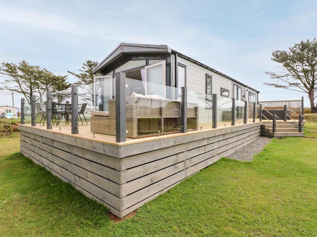a mobile home with a glass roof on the grass at Puffin Lodge in Haverfordwest