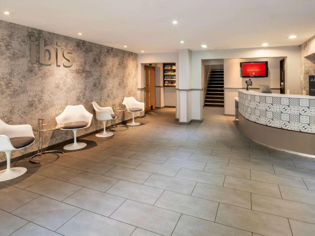 a salon with white chairs and a waiting room at ibis York Centre in York