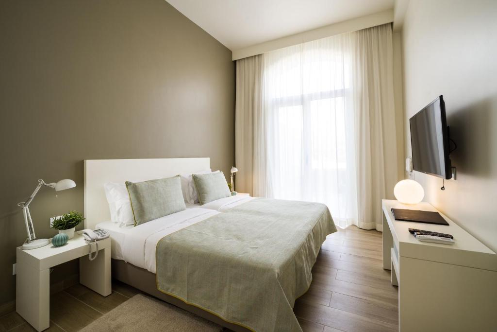 Postel nebo postele na pokoji v ubytování Oasis Tarrafal Alfandega Suites