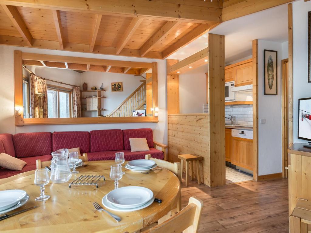 a dining room and living room with a wooden table at Studio Courchevel 1650, 1 pièce, 5 personnes - FR-1-563-91 in Courchevel